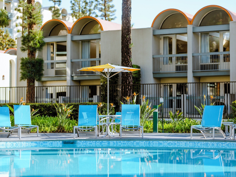 a pool with chairs and umbrellas